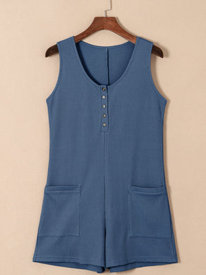 Dusty Blue waffle knit button-down romper with pockets and a scoop neckline.