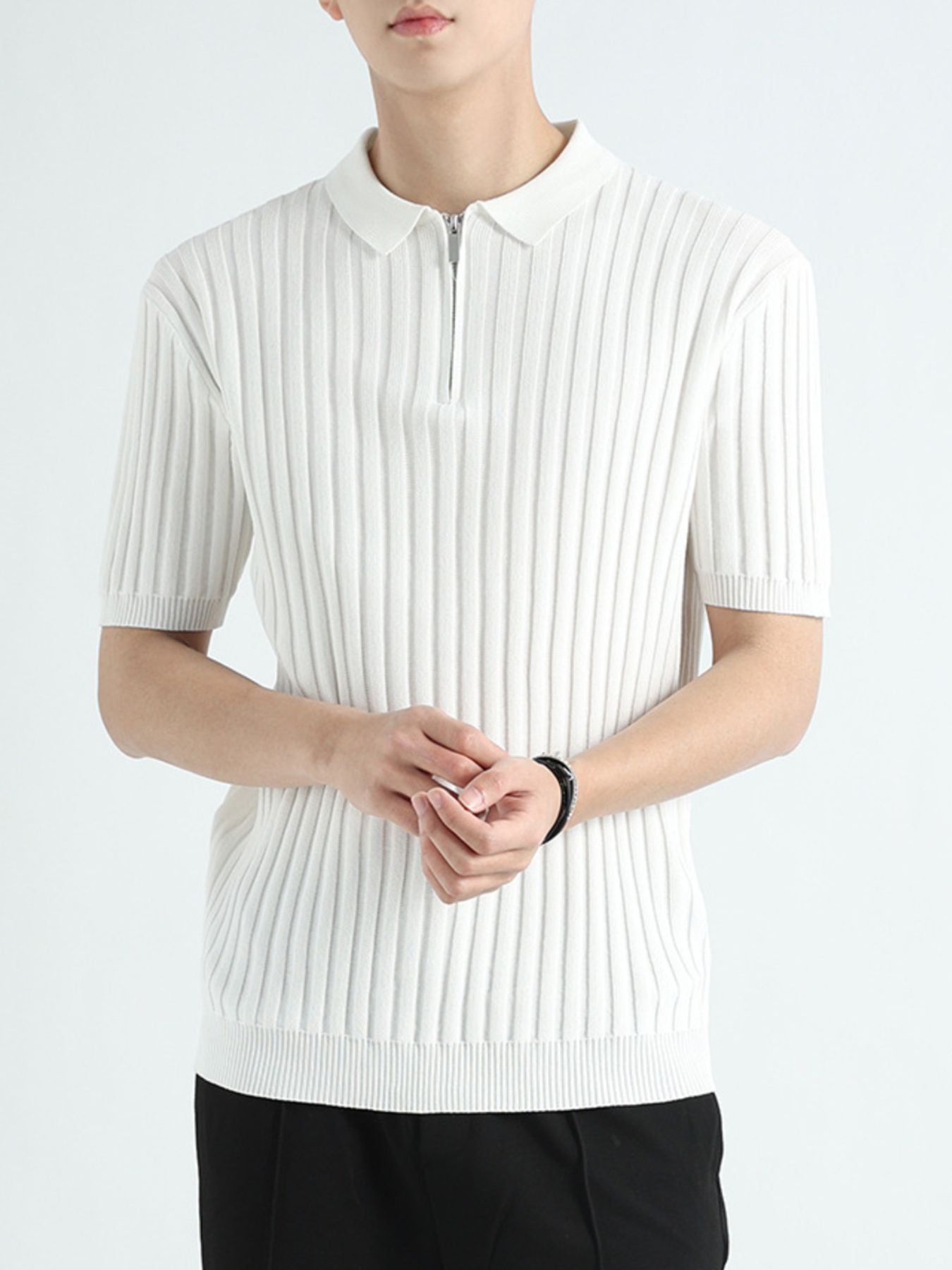 White ribbed knit polo shirt with zip neck and short sleeves.