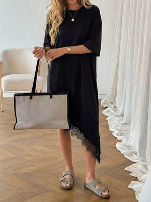 Black asymmetrical t-shirt dress with lace trim detail and short sleeves.
