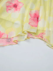 Yellow floral asymmetrical mini dress with ruffled hem and polka dot detail.