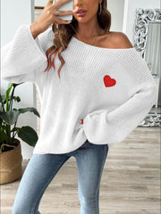 White slouchy boatneck knit sweater with embroidered red heart detail.