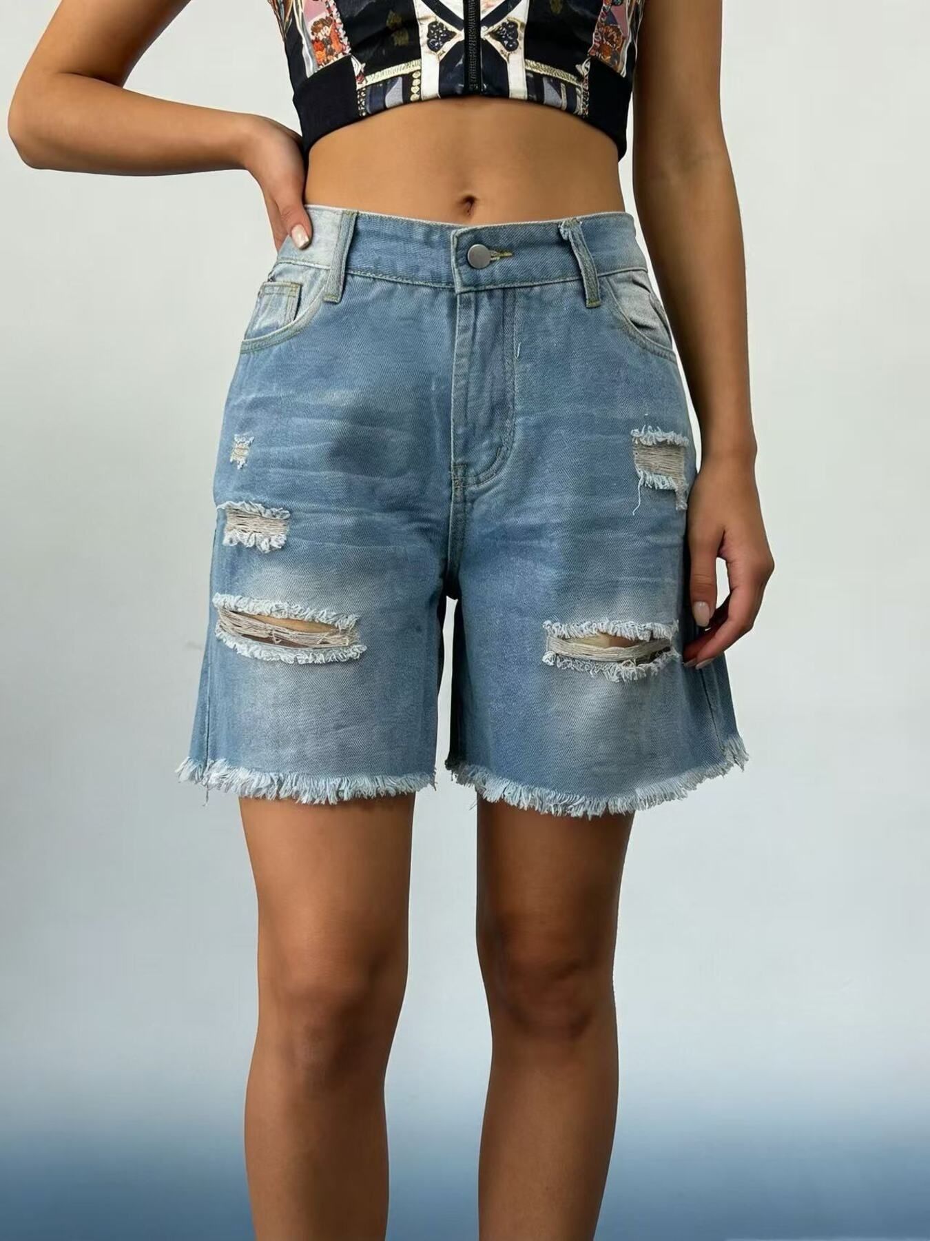 Light blue denim shorts with distressed rips and frayed hem.