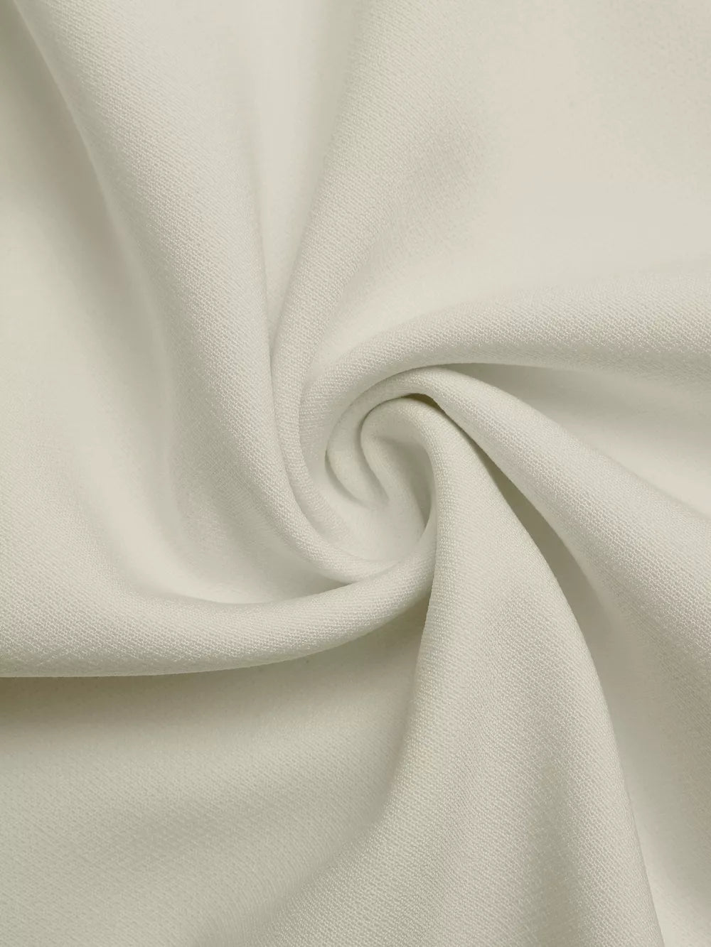 Close-up of textured beige fabric with subtle black trim detail