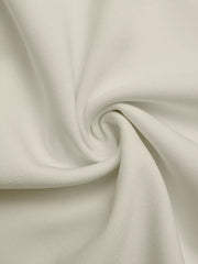 Close-up of textured beige fabric with subtle black trim detail