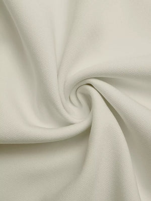Close-up of textured beige fabric with subtle black trim detail