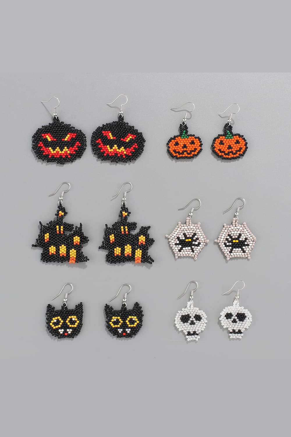 Beaded Halloween earrings featuring pumpkins, haunted houses, black cats, spiders, and skulls.