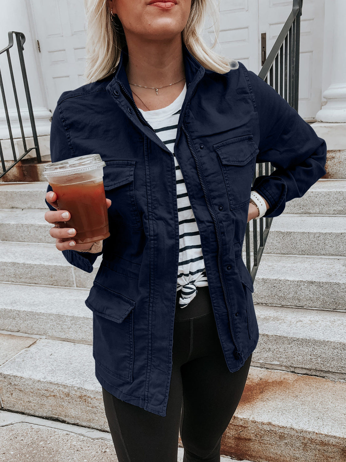 Dark Navy utility jacket with multiple pockets and a zip-up front, styled casually.