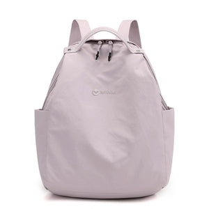 Medium nylon lightweight backpack in blush pink with side pockets and dual zippers.