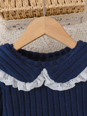 Navy ribbed knit toddler top with white lace Peter Pan collar.