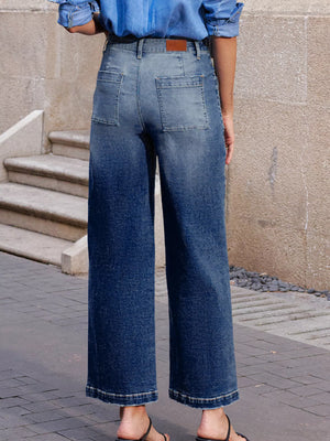 Patch pocket wide-leg jeans in medium wash denim with a gradient effect.