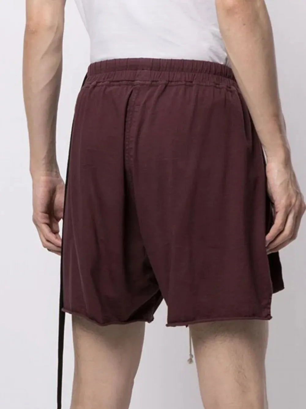 Burgundy lounge shorts with raw hem and drawstring detail.