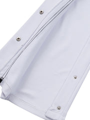 White men's track pants with snap buttons and black contrast stitching detail.