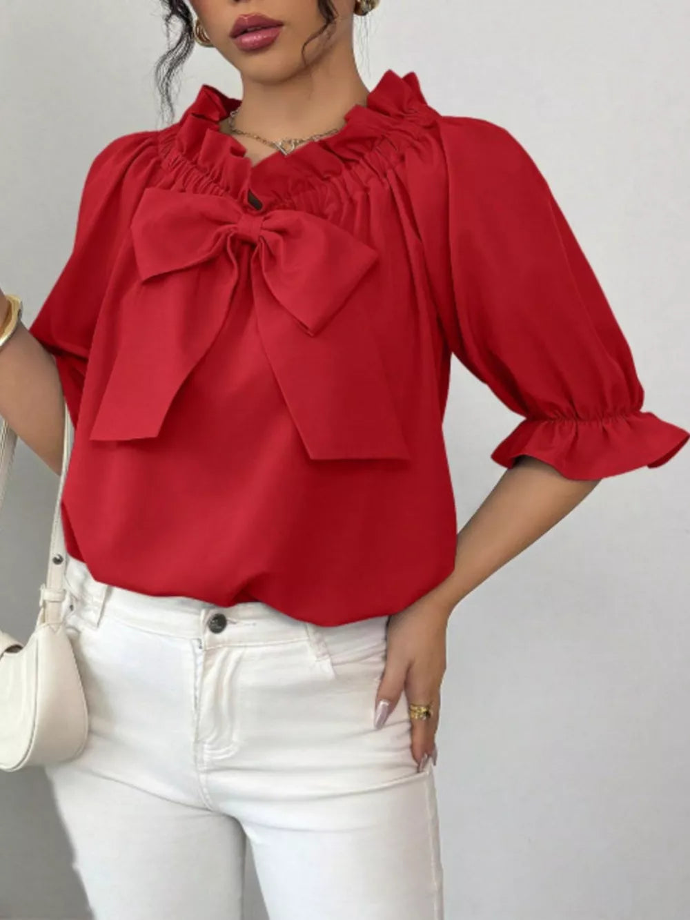 Red ruffled bow sleeve blouse with cinched neckline and ruffled cuffs.