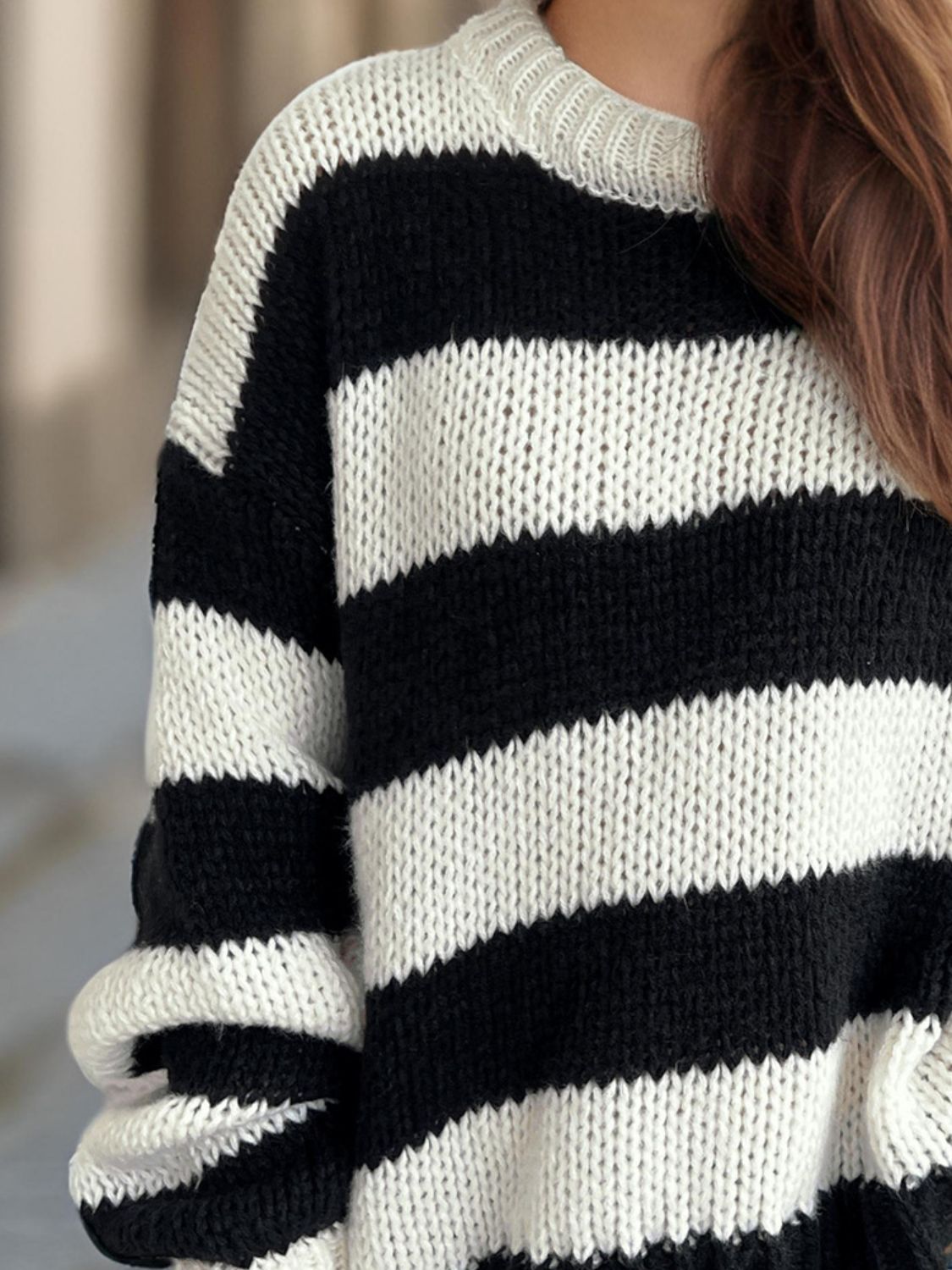 Chunky knit jumper with bold black and white stripes, crew neck, and relaxed fit.