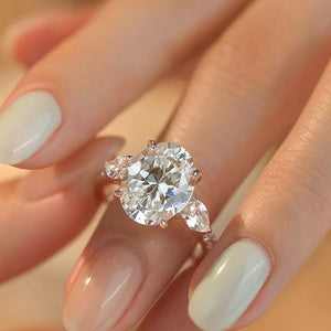 Dazzling Moissanite Oval Ring in Sterling Silver with side pear-cut stones.