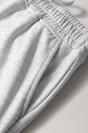 French terry drawstring skort in light gray with pockets and elastic waistband detail.