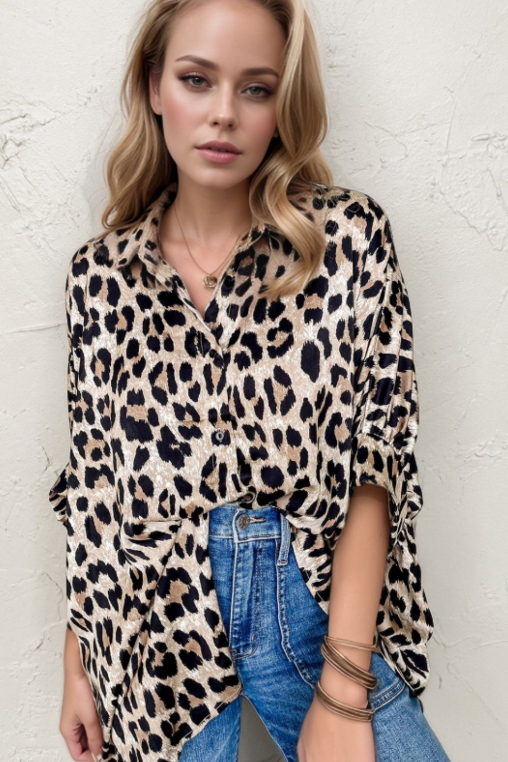 Leopard print oversized button-down blouse with rolled sleeves and a collared neckline.