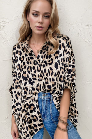 Leopard print oversized button-down blouse with rolled sleeves and a collared neckline.