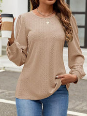 Camel perforated puff sleeve blouse with crew neck and long sleeves.