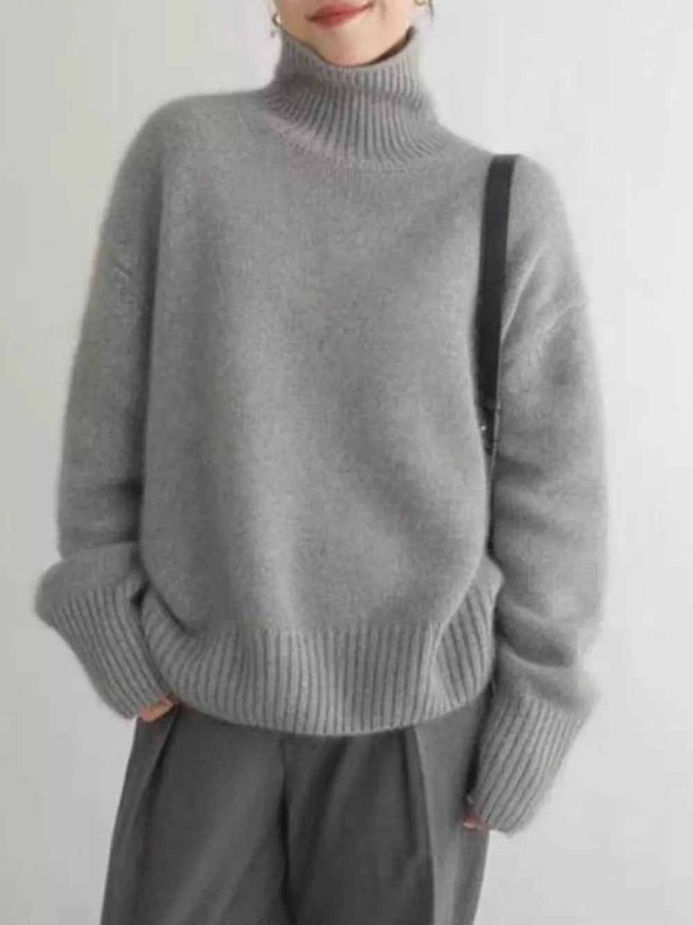 Gray acrylic turtleneck sweater with dropped shoulders and ribbed cuffs and hem.