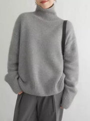 Gray acrylic turtleneck sweater with dropped shoulders and ribbed cuffs and hem.