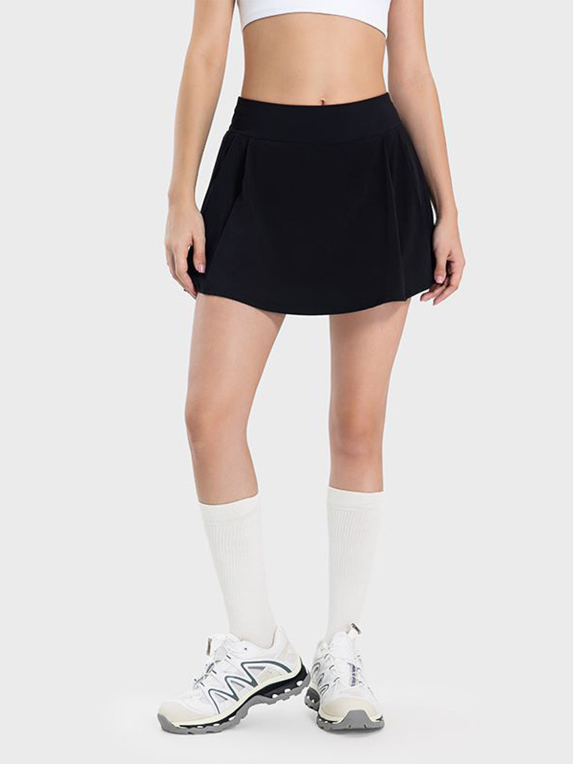 Black pleated performance mini skirt with a comfortable fit