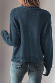 Peacock blue knit cardigan with mesh detail on the sleeves.