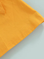 Yellow knit baby outfit detail showing bow and stitching.