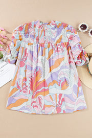 Psychedelic print smocked puff sleeve blouse with a high neckline in multicolor.