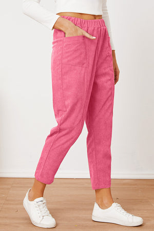 Hot Pink corduroy barrel-leg utility pants with elastic waist and pockets.