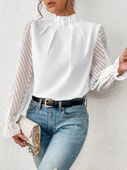 White chevron sleeve ruffle neck blouse with mock neck and ruffled cuffs.