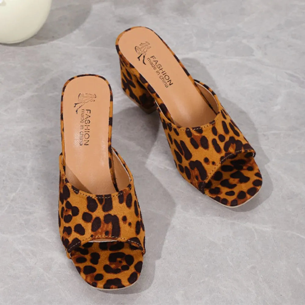 Leopard print block heel mules with open toe and tan insoles.
