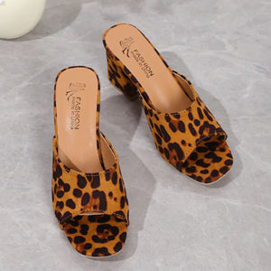Leopard print block heel mules with open toe and tan insoles.