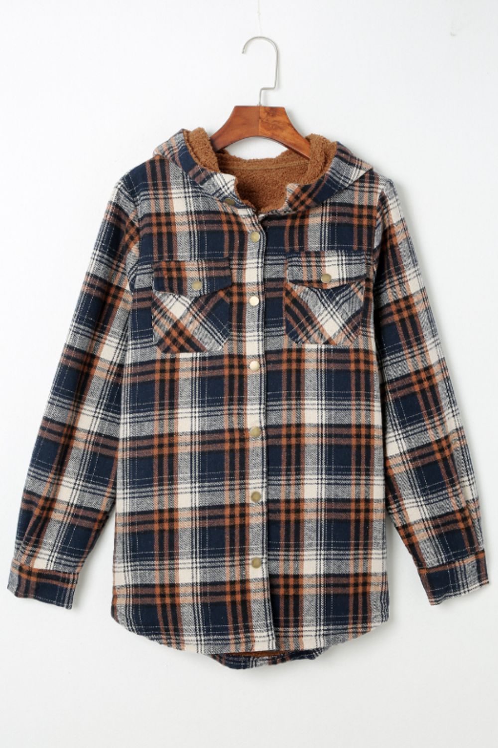 Sherpa-lined plaid overshirt jacket in navy, tan, and cream with button front and chest pockets.