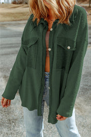Green button-up coat with two chest pockets and textured fabric.