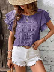 Purple smocked blouse with ruffle sleeves and textured fabric.