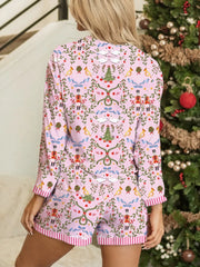 Pink nutcracker print pajama set with button-down top and shorts.