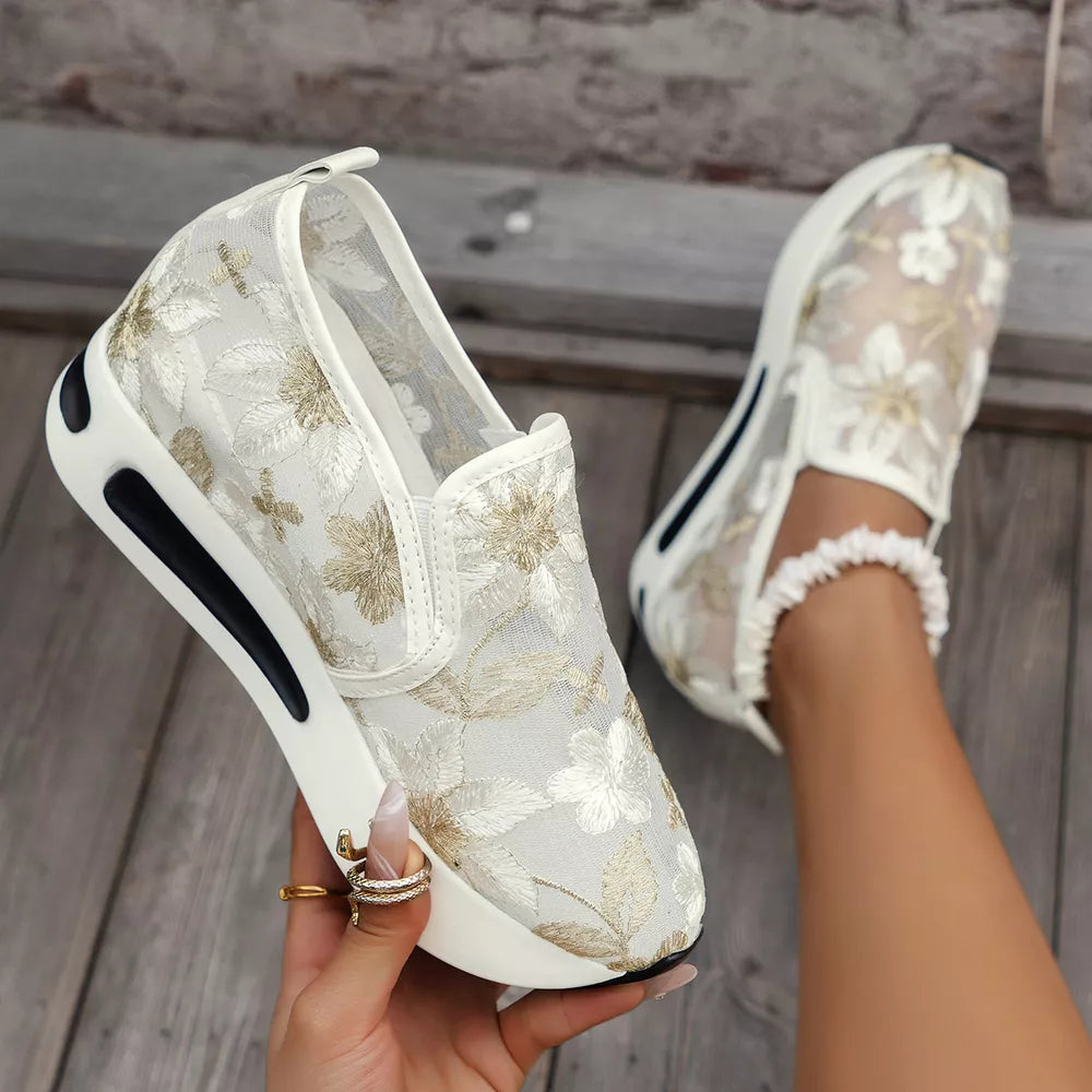 Chic floral embroidered white mesh slip-on sneakers with a chunky platform sole.