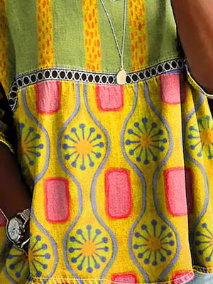 Bohemian maternity t-shirt in yellow with floral and geometric print, openwork detail, and striped green yoke.