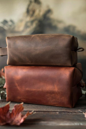 Textured faux leather travel cases in mocha and caramel with carry handles.