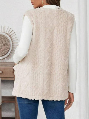 Textured sherpa vest in Dust Storm with cable knit pattern and open front.