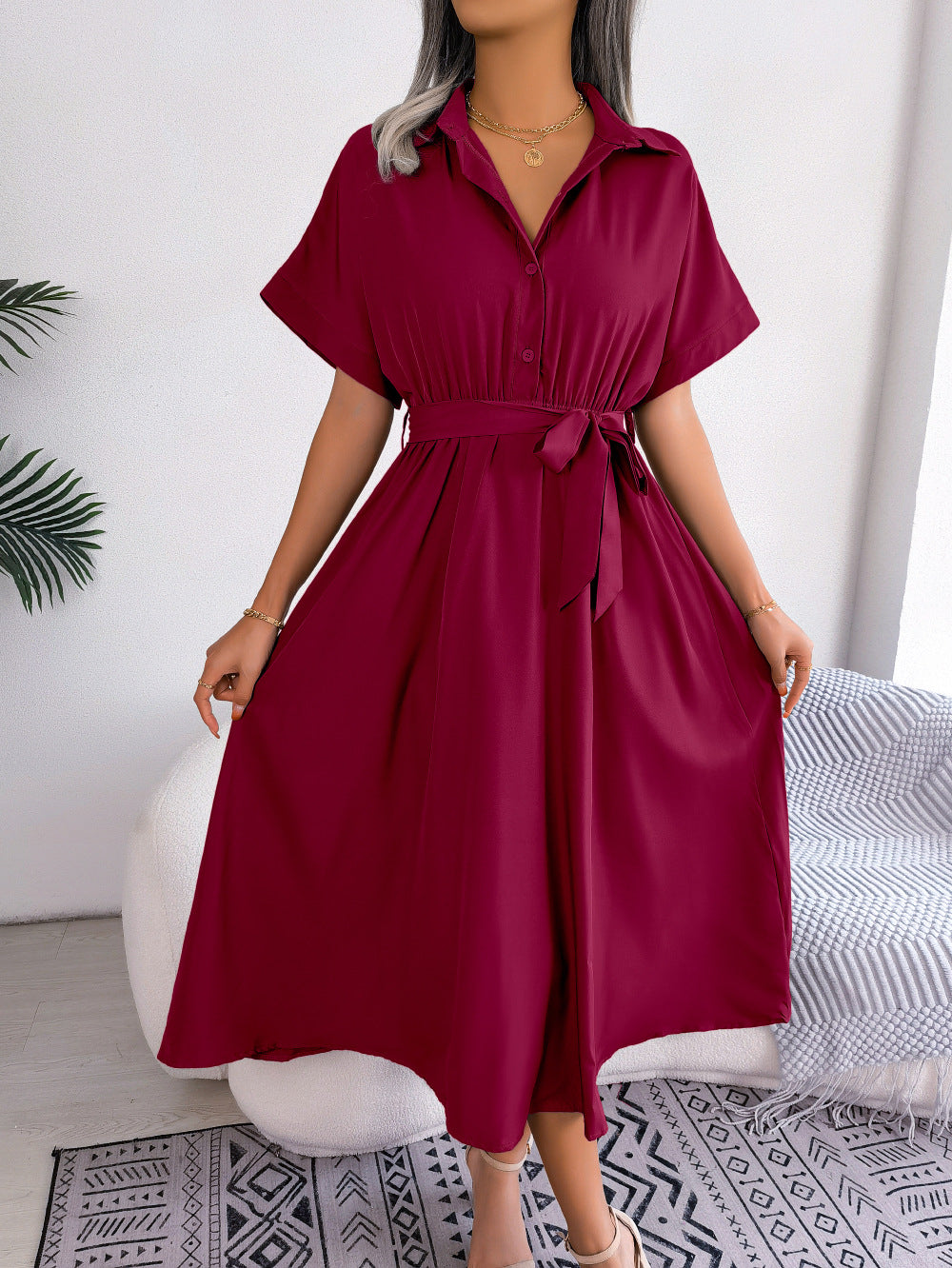Burgundy button-down midi dress with short sleeves and a tie belt.