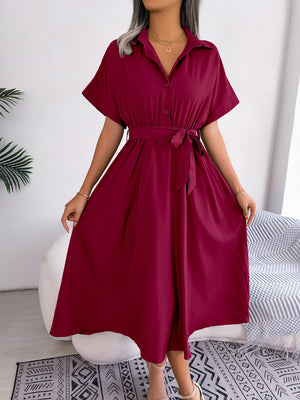 Burgundy button-down midi dress with short sleeves and a tie belt.