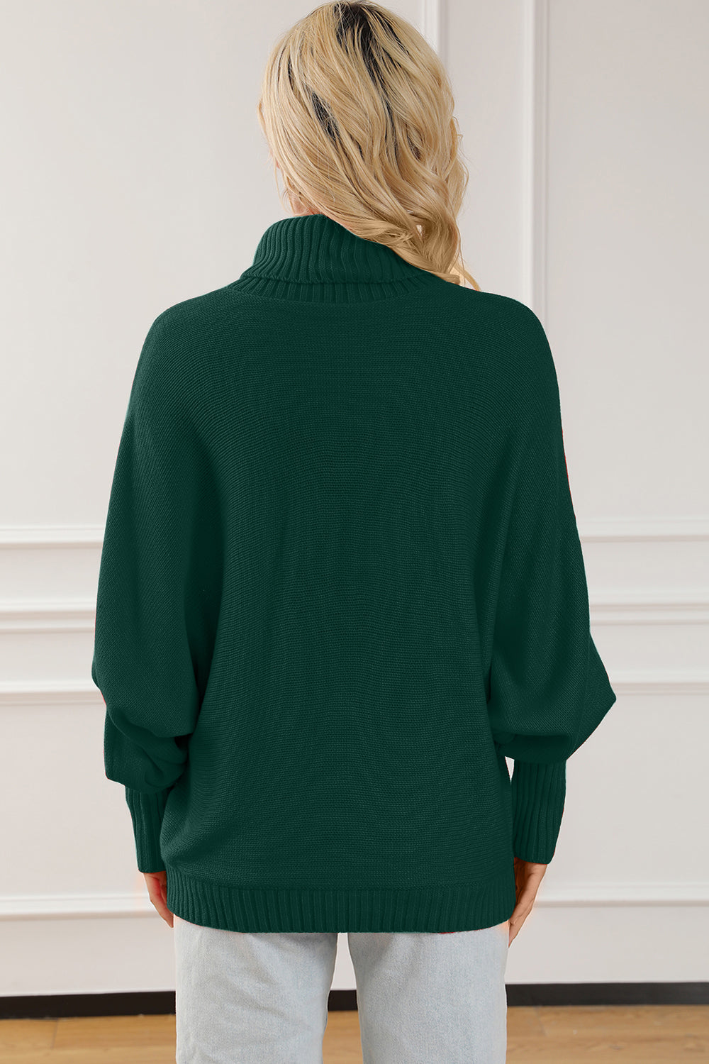 Green acrylic turtleneck sweater with dolman sleeves and ribbed cuffs and hem.