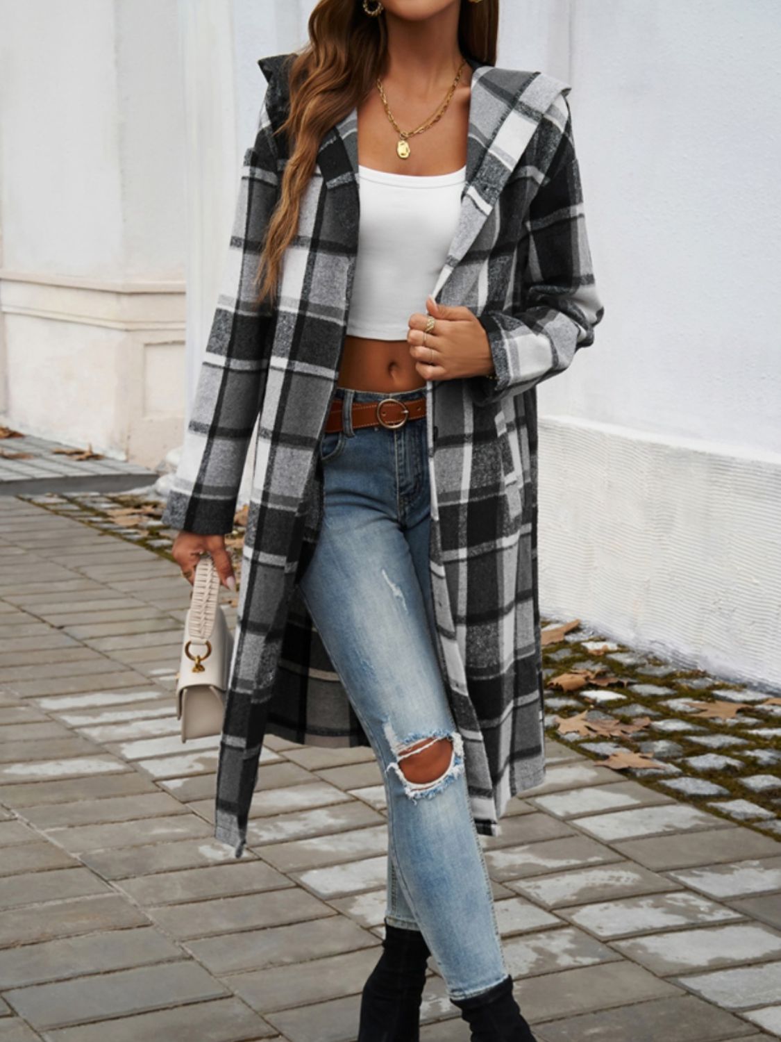 Checked plaid hooded duster coat in black and white, open front, long sleeves, duster length