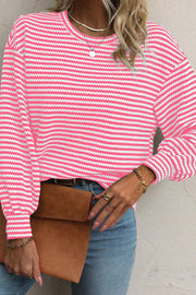 Pink and white striped textured knit top with balloon sleeves.