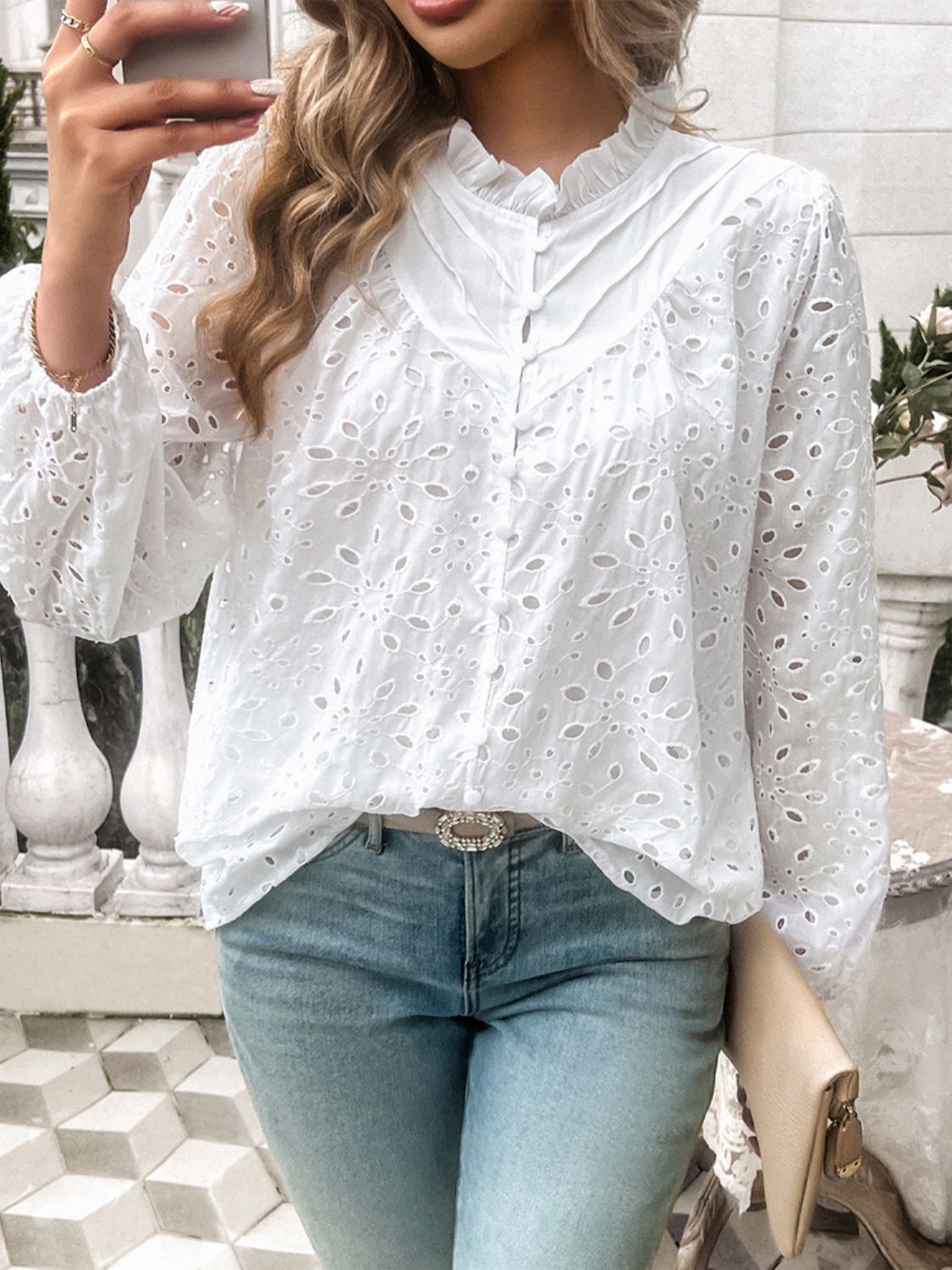 White eyelet embroidered blouse with ruffle collar and button front.