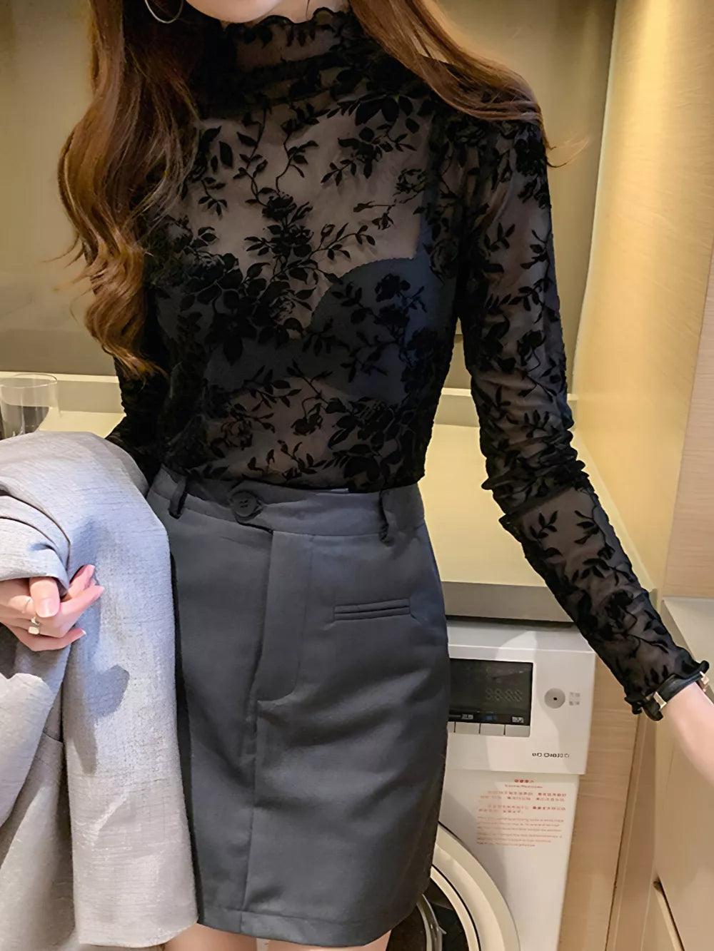 Black sheer floral fitted t-shirt with mock neck and ruffled cuffs.