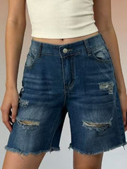 Distressed dark blue denim shorts with frayed hem and ripped details.