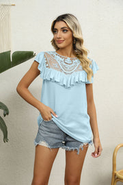 Light blue blouse with lace yoke, ruffle neckline and short sleeves.